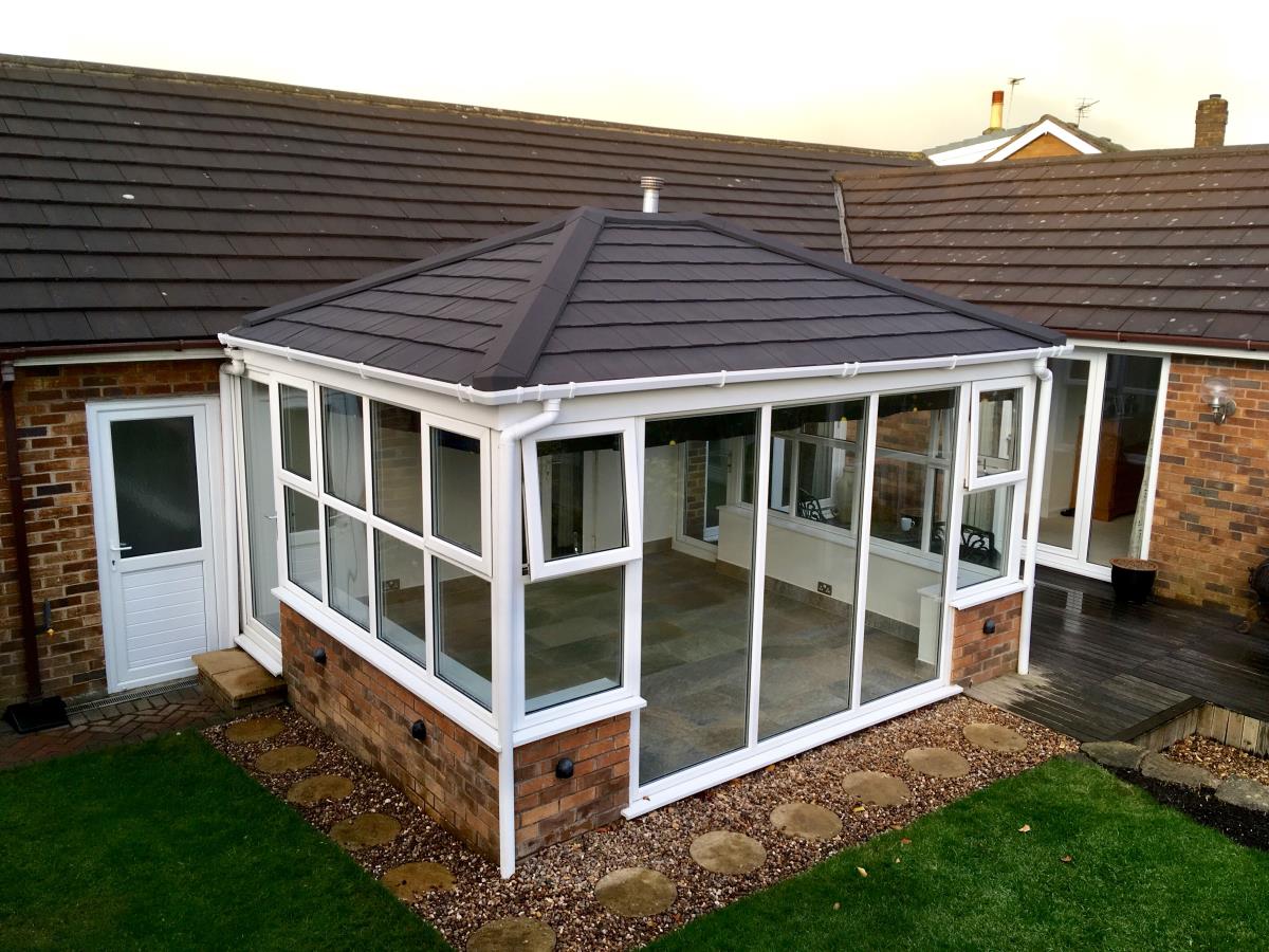 An ebony metrotile shingle conservatory roof to match the existing house tiles in Stanah, Thornton.