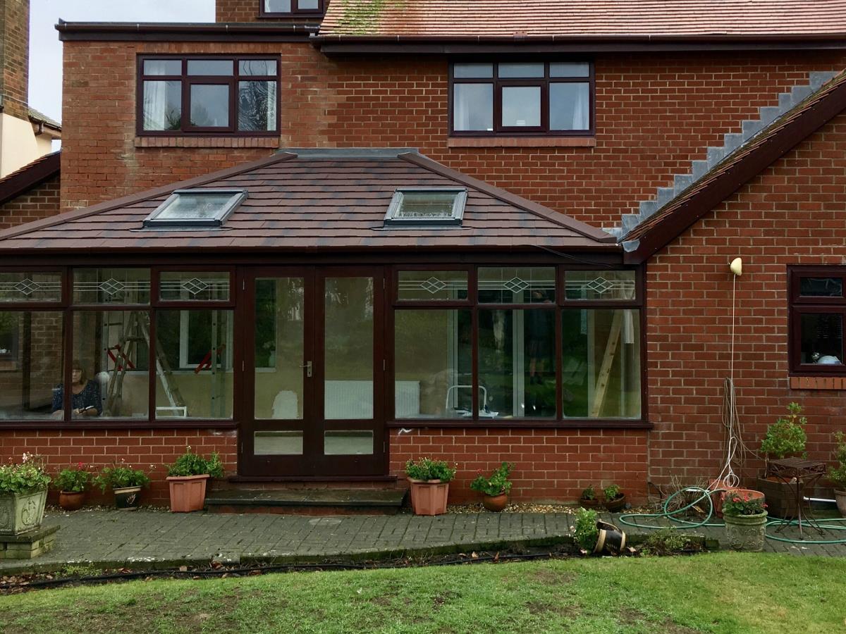 Replacement solid shingle roof for a large Fleetwood conservatory in burnt umber.