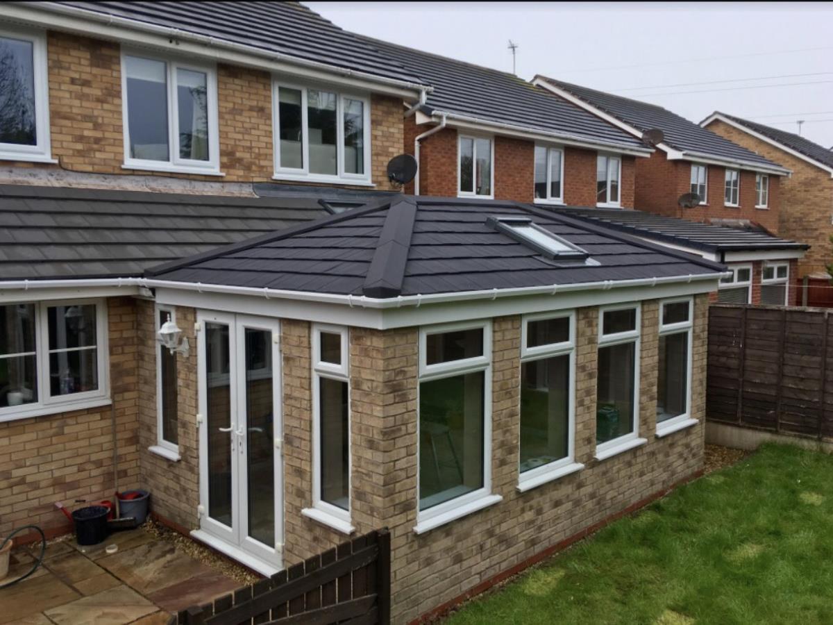 Ebony metrotile shingle styled conservatory roof with a velux window for a Blackpool client.
