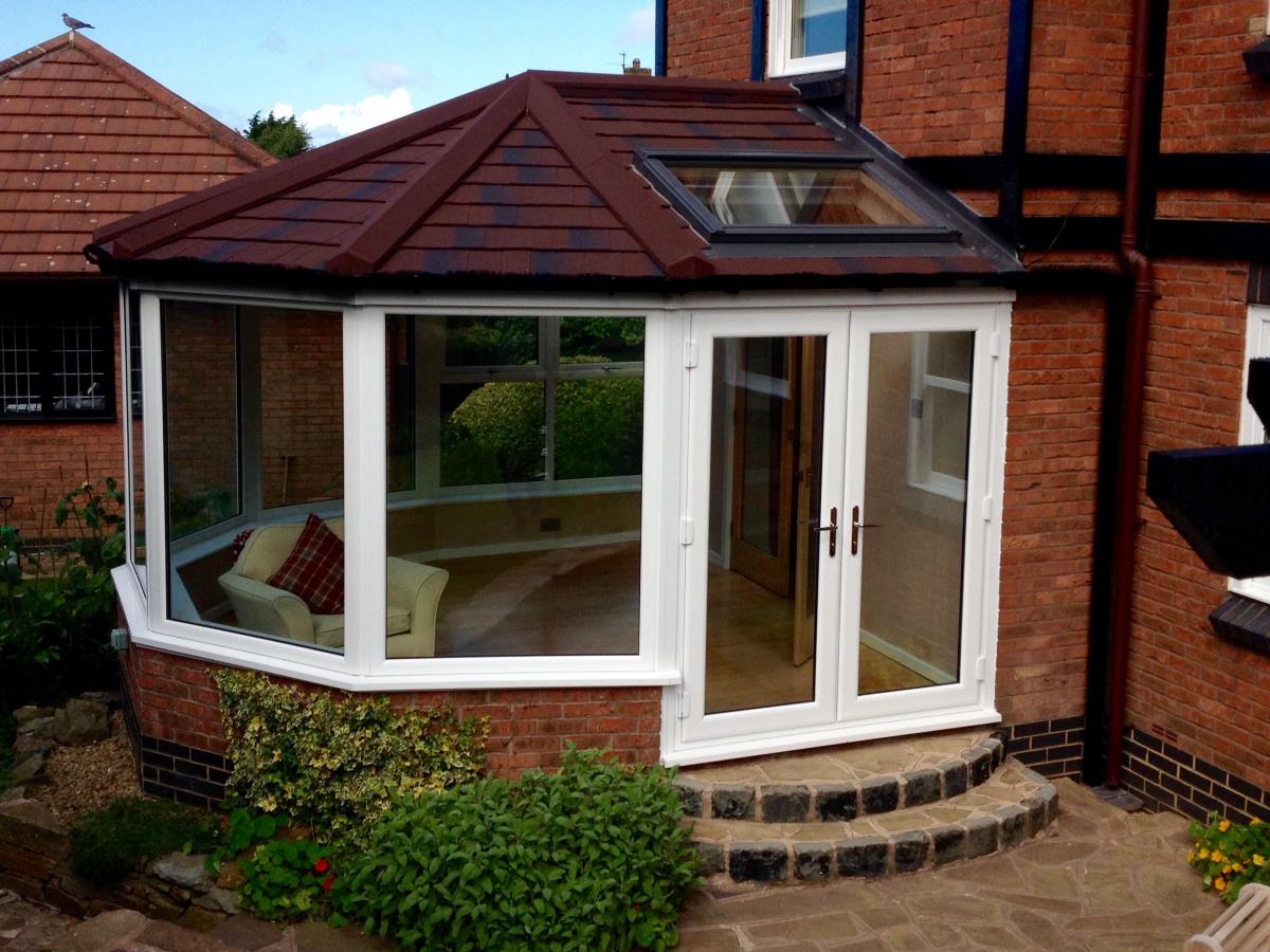 Conservatory roof conversion featuring a burnt umber shingle roof for a Cleveleys property.