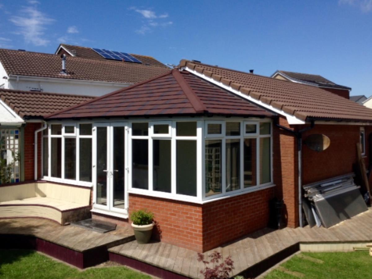 Burnt umber Georgian conservatory solid roof conversion to match roof-line of existing Lytham St Annes property.