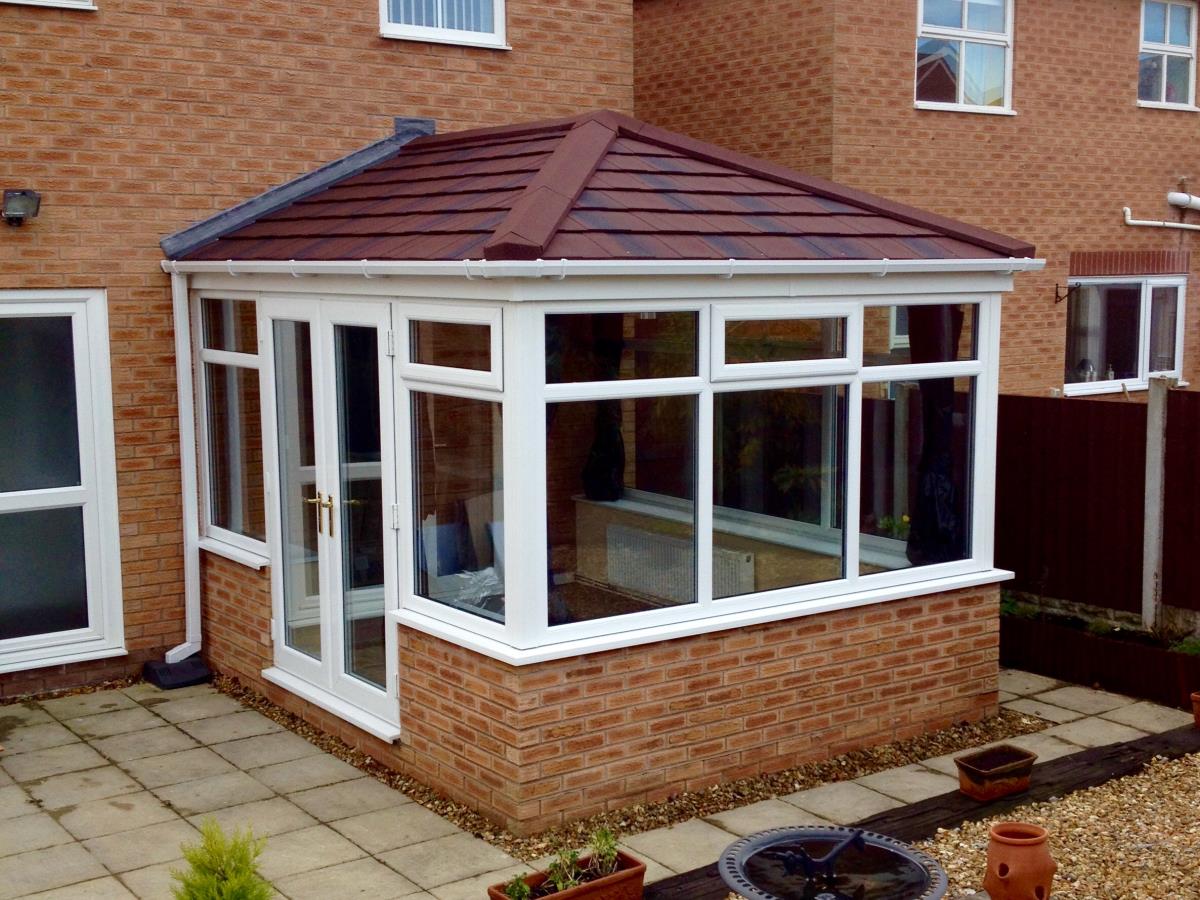 Umber shingle styled tiling for a conservatory roof in Thornton.